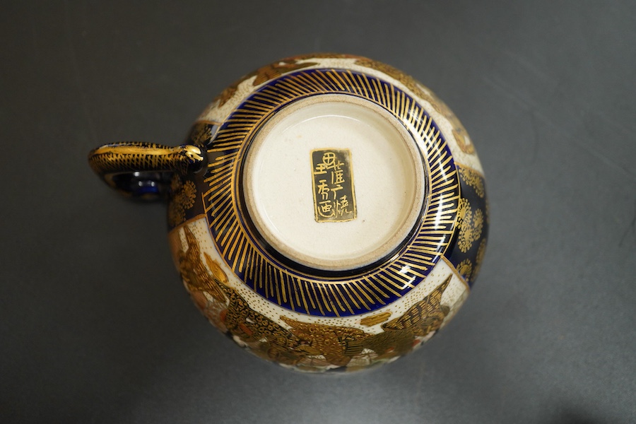 A Japanese satsuma pottery cup and saucer, saucer 14cm in diameter
